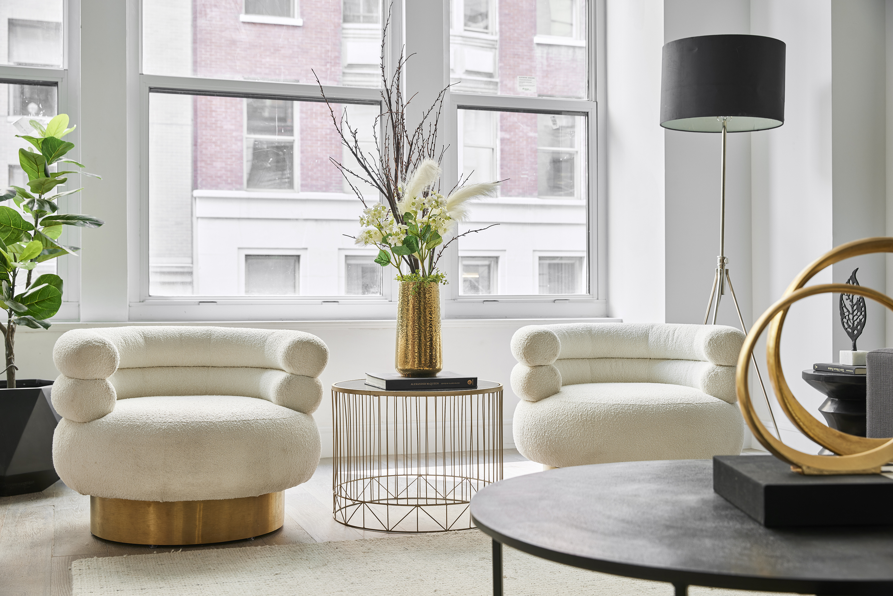 Winter white upholstered chairs help add a sense of contrast in a living space.