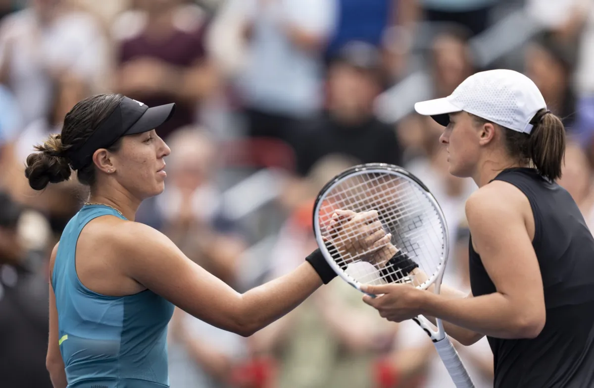 Jessica Pegula of the United States (L) shakes hands with Iga Swiatek of Poland following the semifinals of the National Bank Open women’s tennis tournament in Montreal on Aug. 12, 2023. (Christinne Muschi/The Canadian Press via AP)