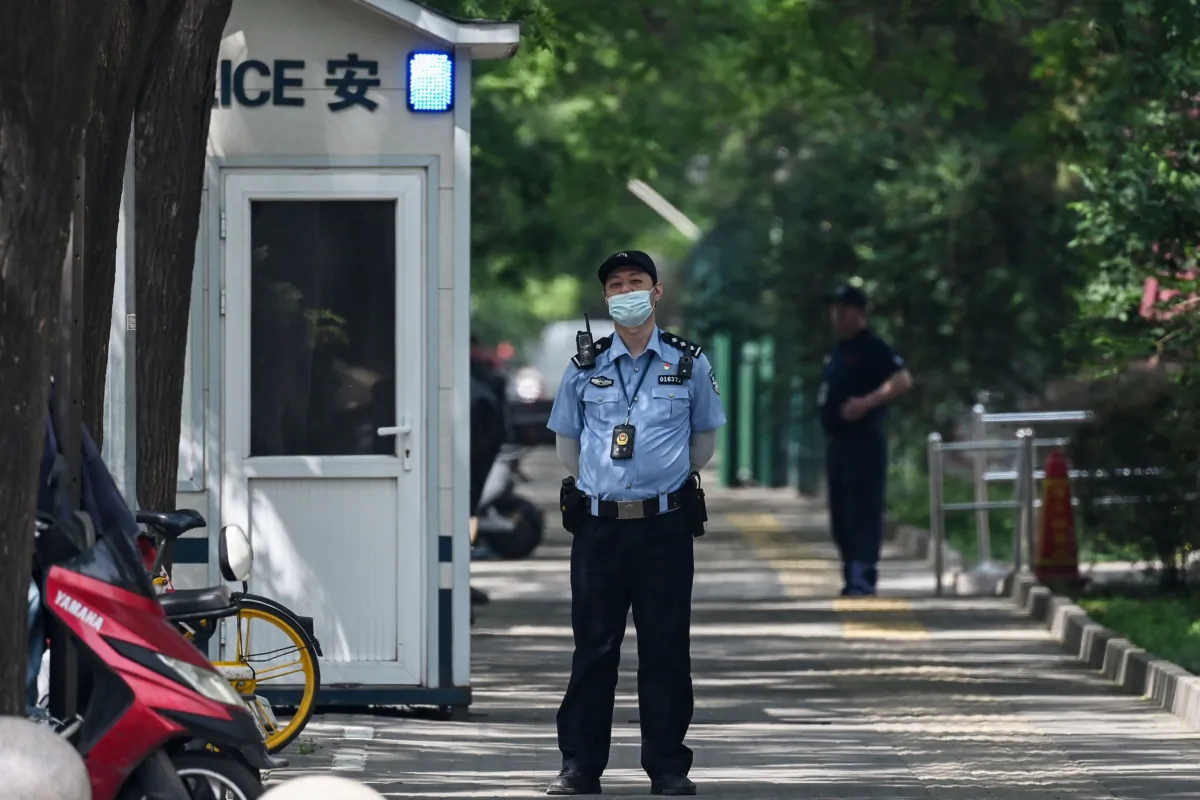 A police officer stands outside the Canadian Embassy in Beijing on May 9, 2023. (Greg Baker/AFP via Getty Images)