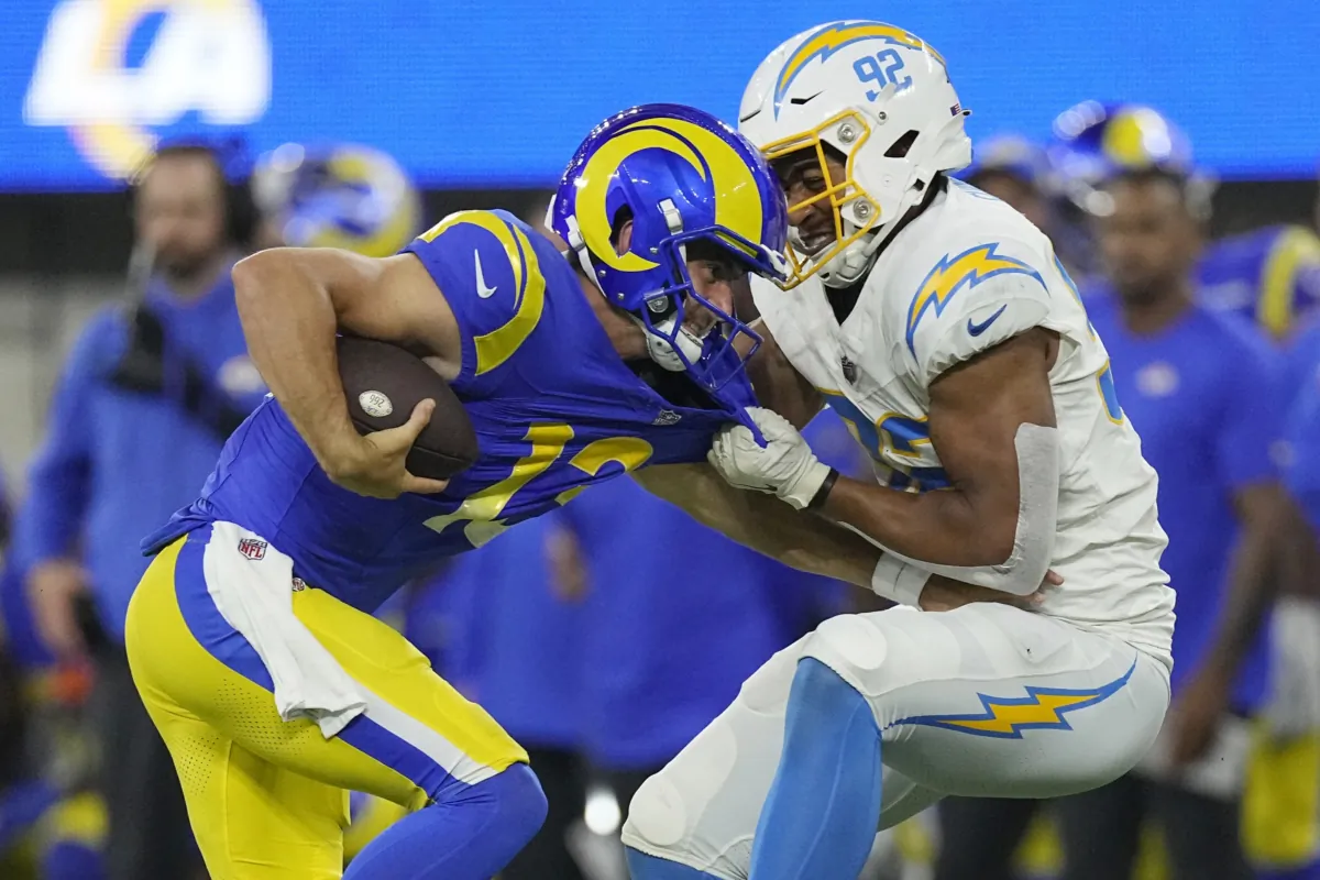 Los Angeles Rams quarterback Stetson Bennett (L) is tackled by Los Angeles Chargers linebacker Andrew Farmer during the second half of a preseason NFL football game in Inglewood, Calif., on Aug. 12, 2023. (Mark J. Terrill/AP Photo)