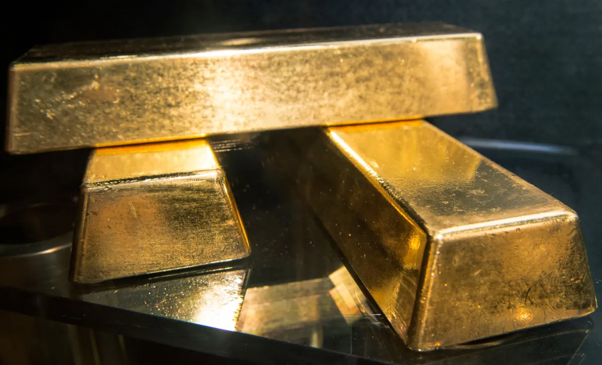 Three .9999 fine gold bars, 400 troy ounces or 28 lbs each, with a combined value of more than USD 2 million, are displayed at the Bureau of Engraving and Printing (BEP) in Washington, on Aug. 27, 2012. (PAUL J. RICHARDS/AFP via Getty Images)