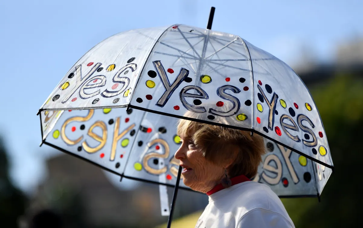 Supporters hold merchandise in support of the vote during a Yes 23 community event in support of an Indigenous Voice to Parliament, in Sydney, Australia, on July 2, 2023. (AAP Image/Bianca De Marchi)