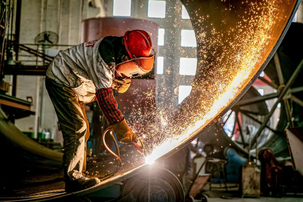 A worker produces engineering equipment for export at a factory in Nantong, Jiangsu Province, China, on March 30, 2021. (STR/AFP via Getty Images)