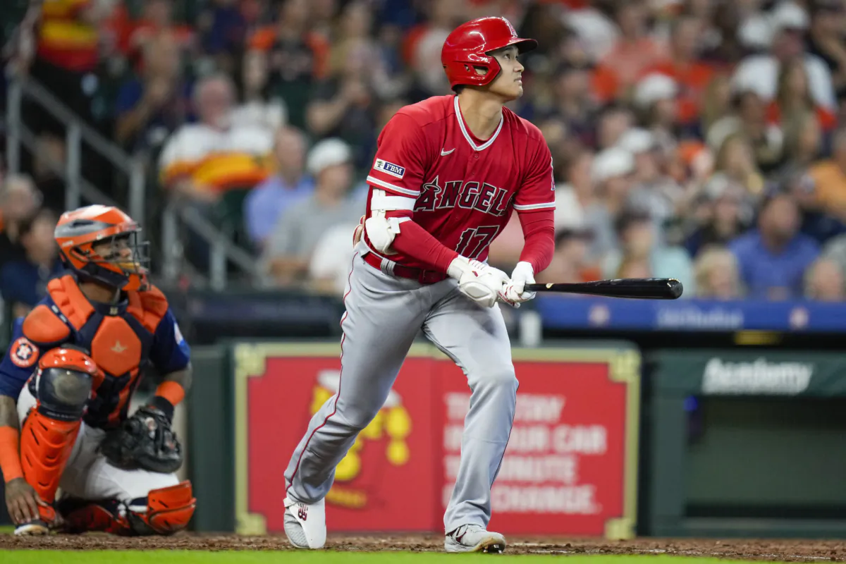 Los Angeles Angels designated hitter Shohei Ohtani, right, watches his solo home run during the sixth inning of a baseball game against the Houston Astros in Houston on Aug. 13, 2023. (Eric Christian Smith/AP Photo)