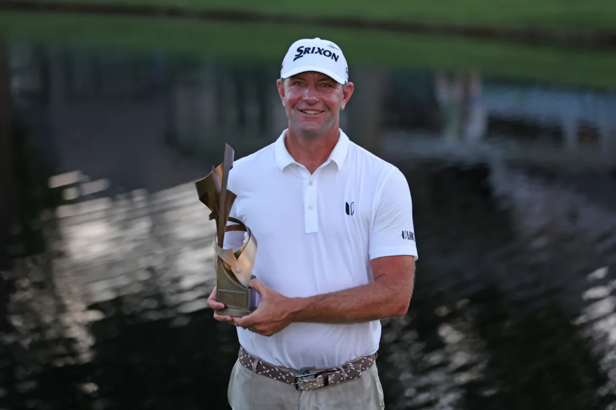 Lucas Glover of the United States poses with the trophy after putting in to win during the first playoff hole on the 18th green to win the tournament during the final round of the FedEx St. Jude Championship at TPC Southwind in Memphis on August 13, 2023. (Gregory Shamus/Getty Images)