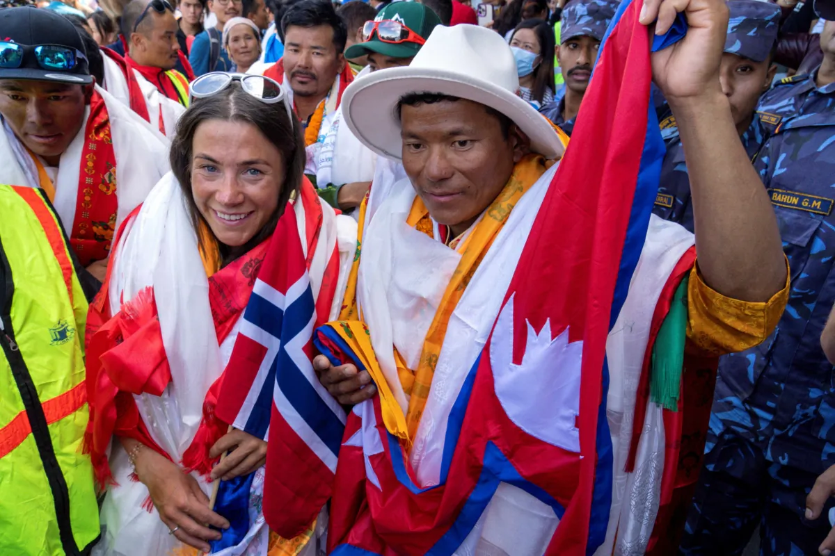 Norwegian climber Kristin Harila (L), and her Nepali sherpa guide Tenjen Sherpa (R), who climbed the world's 14 tallest mountains in record time, arrive in Kathmandu, Nepal, on Aug. 5, 2023. (Niranjan Shrestha/AP Photo)