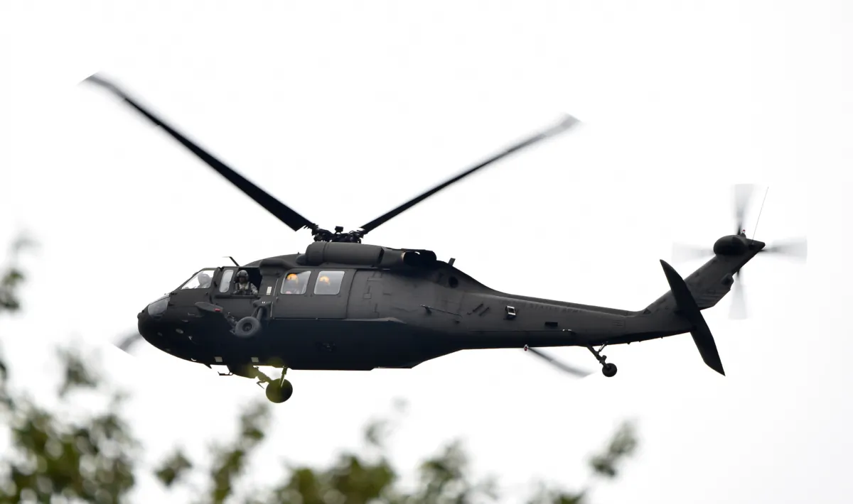 A national guard helicopter flies over the damaged by the recent flash floods area in Columbia, S.C., on Oct. 5, 2015. (Mladen Antonov/AFP via Getty Images)