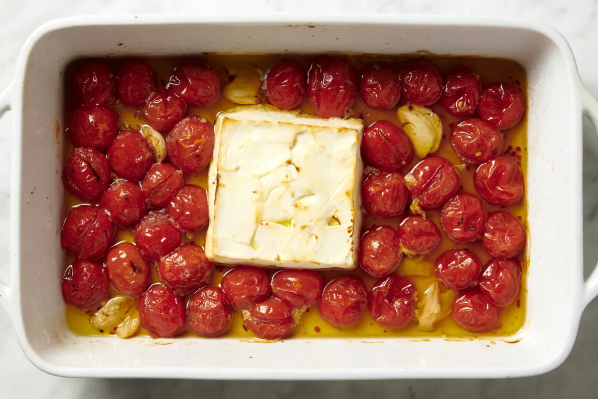 This easy recipe, inspired by the TikTok-famous feta pasta, features burst cherry tomatoes, roasted garlic, lemon zest, basil, and a creamy feta sauce. (Alex Lepe/TNS)