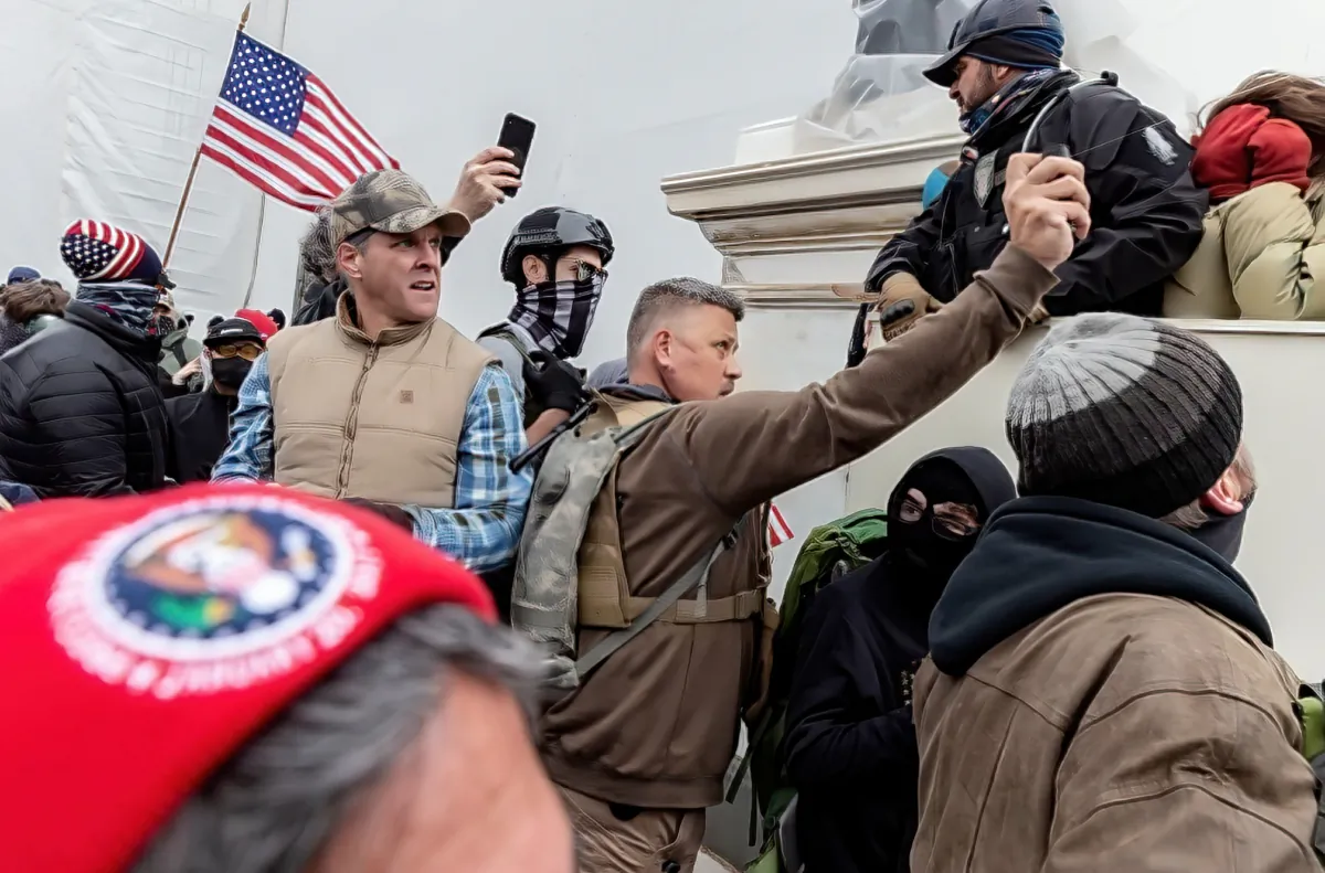 Christopher J. Worrell sprays pepper gel toward the police line on the west front of the Capitol on Jan. 6, 2021. (U.S. Department of Justice/Screenshot via The Epoch Times)
