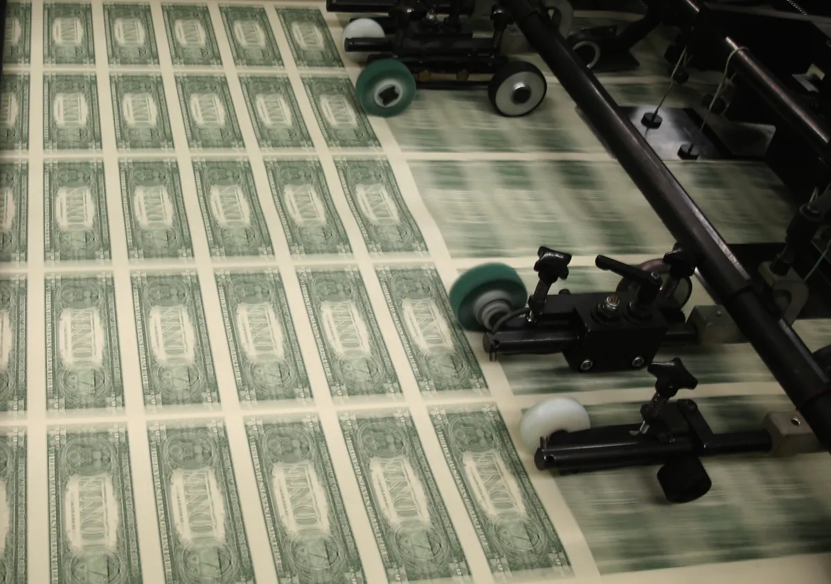 Sheets of $1 bills run through the printing press at the Bureau of Engraving and Printing in Washington, on March 24, 2015. (Mark Wilson/Getty Images)