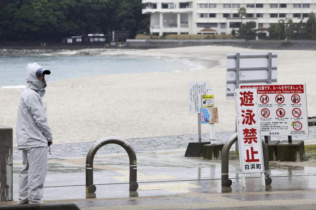 A person stands near a swimming beach in Shirahama, Wakayama prefecture, western Japan, on Aug. 14, 2023. (Kyodo News via AP)