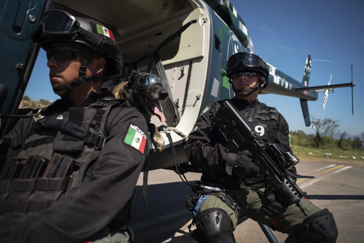 The trainer of the company K-9 of the Civil Force of Veracruz, Daniel Ortega, (R), takes part in an exhibition accompanied by the canine agent "Sheriff" within the framework of the International Tactical Diploma K-9 Multipurpose Dogs, in the municipality of Emiliano Zapata, state of Veracruz, Mexico, on March 5, 2021. (Victoria Razo/AFP via Getty Images)