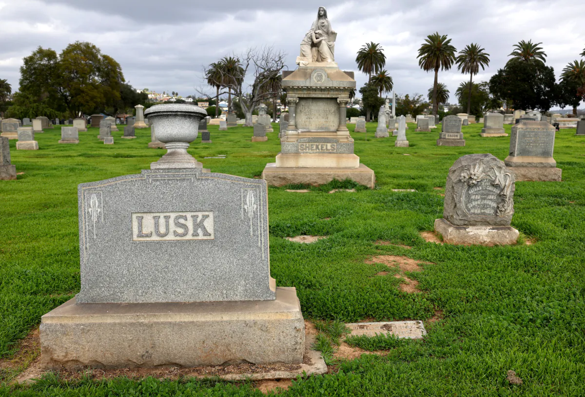 Gravestones stand above green grass at Evergreen Cemetery in Los Angeles on Feb. 14, 2023. (Mario Tama/Getty Images)