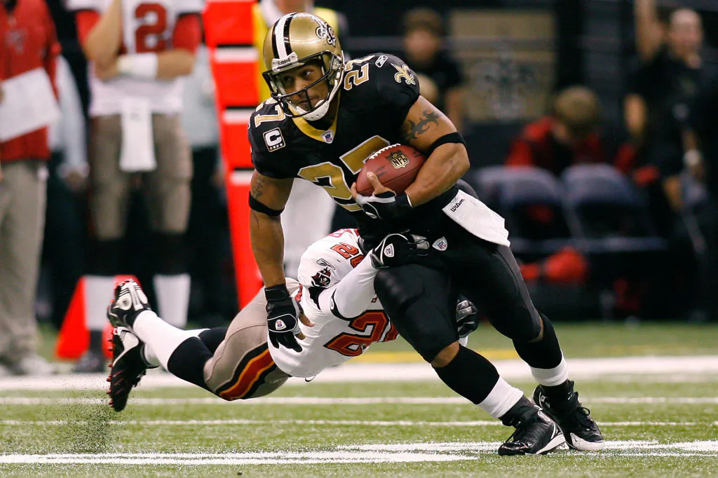 Aaron Stecker (27) of the New Orleans Saints avoids a tackle by Ronde Barber (20) of the Tampa Bay Buccaneers at the Louisiana Superdome in New Orleans, La., on Dec. 2, 2007. (Chris Graythen/Getty Images)