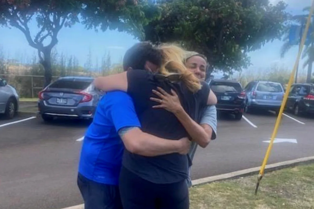 Mike Cicchino (L), and his wife Andreza (R), hugs Mike's mother Susan Ramos as they were reunited at shelter in Maui, Hawaii on Aug. 9, 2023. (Mike Cicchino via AP)