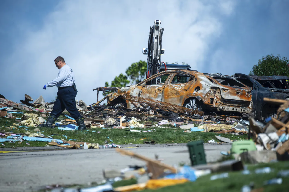An investigator walks through the debris from a home explosion which occurred the day before in Plum, Pa., on Aug. 13, 2023. (Lucy Schaly/Pittsburgh Post-Gazette via AP)