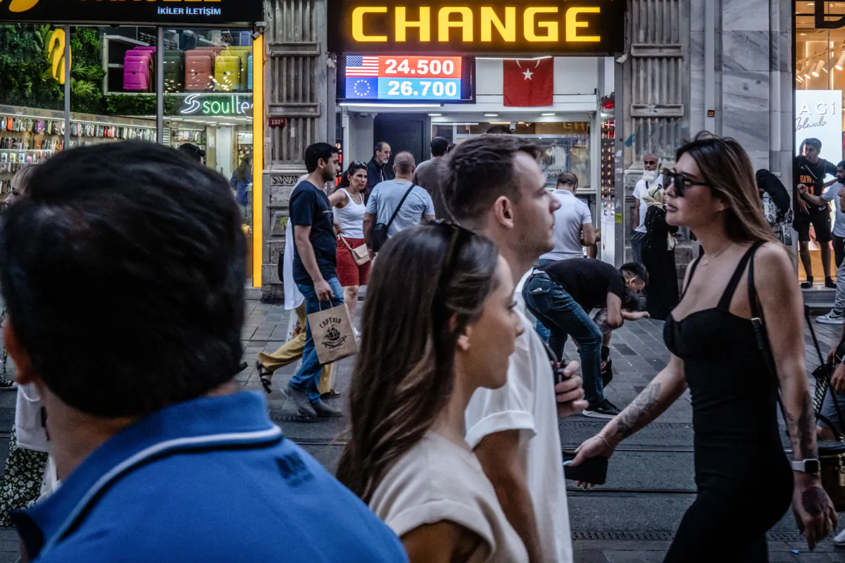 People walk past a currency exchange shop in Istanbul, Turkey on June 23, 2023. Chris McGrath/Getty Images)
