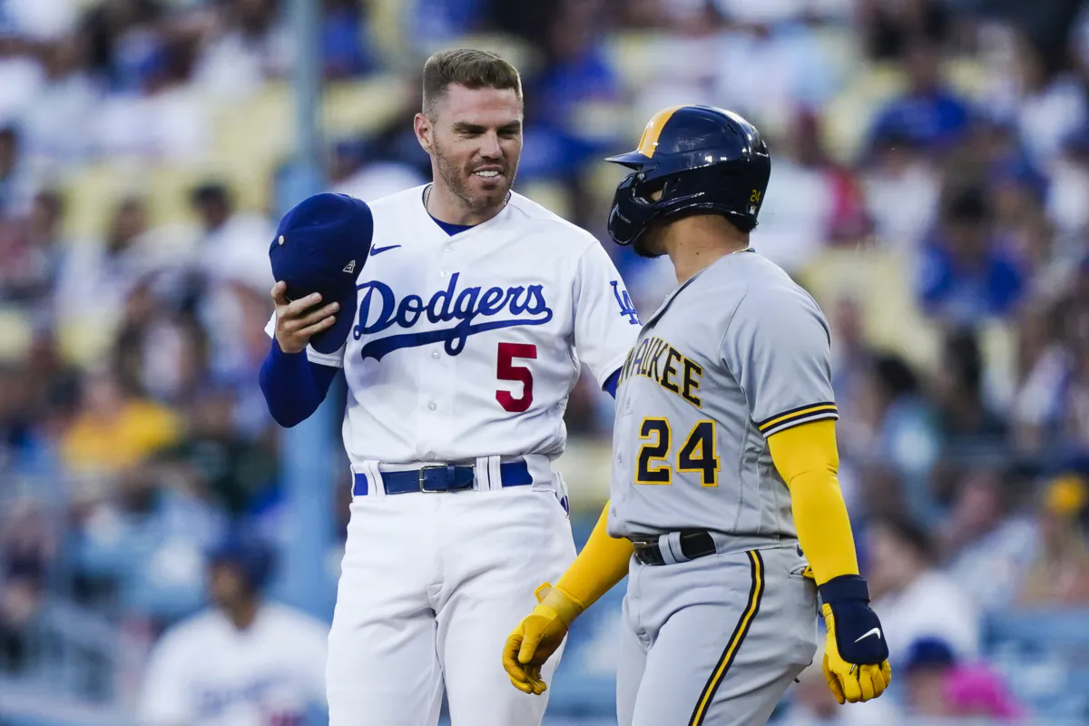 Los Angeles Dodgers first baseman Freddie Freeman (5) talks to Milwaukee Brewers' William Contreras (24) during the first inning of a baseball game in Los Angeles on Aug. 15, 2023. (Ryan Sun/AP Photo)