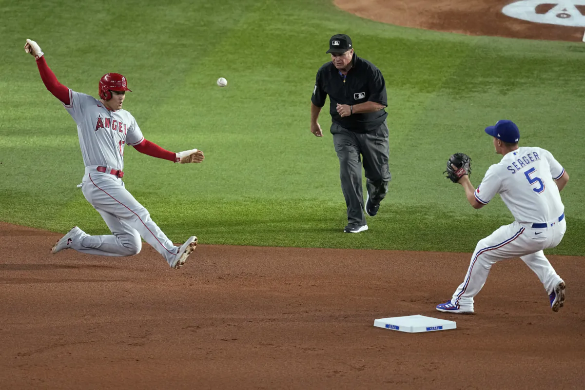 Los Angeles Angels' Shohei Ohtani slides into second, as Texas Rangers shortstop Corey Seager waits for the throw during the first inning of a baseball game in Arlington, Texas, on Aug. 15, 2023. (Tony Gutierrez/AP Photo)