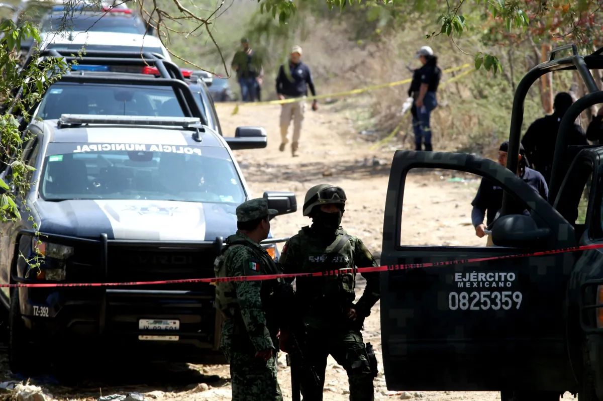 Members of the Mexican Army work at the site of an explosive attack against a police patrol in Tlajomulco de Zuñiga, a suburb at the city of Guadalajara, Jalisco State, Mexico, on July 12, 2023. (Ulises Ruiz/AFP via Getty Images)
