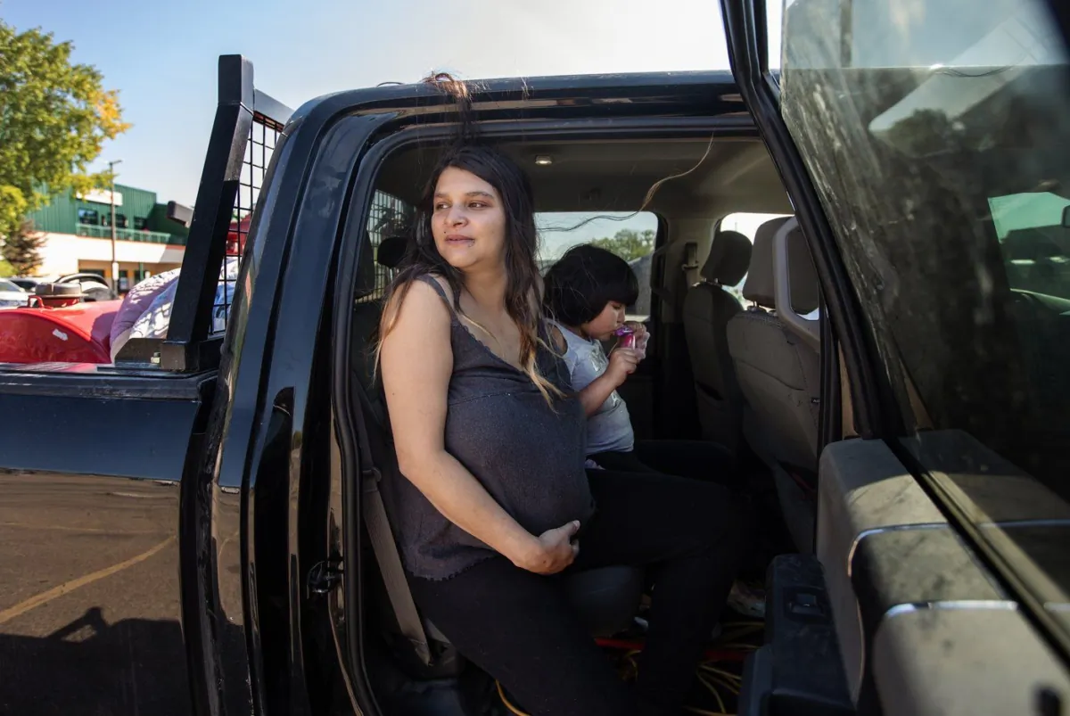 Tanisha Edison, from Hay River, N.W.T, and her daughter Delilah Betsaka are photographed outside an evacuee cente in St. Albert, Alta., on Aug. 16, 2023. (The Canadian Press/Jason Franson)
