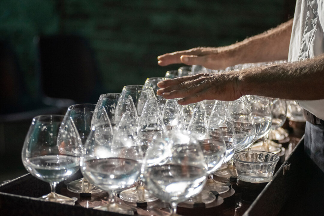 A musician plays melodies on a series of crystal glasses, known as singing glasses. (Federico Magonio/Shutterstock)