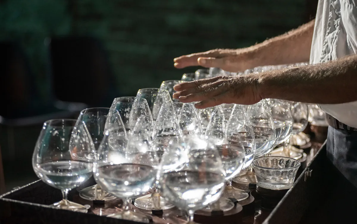 A musician plays melodies on a series of crystal glasses, known as singing glasses. (Federico Magonio/Shutterstock)
