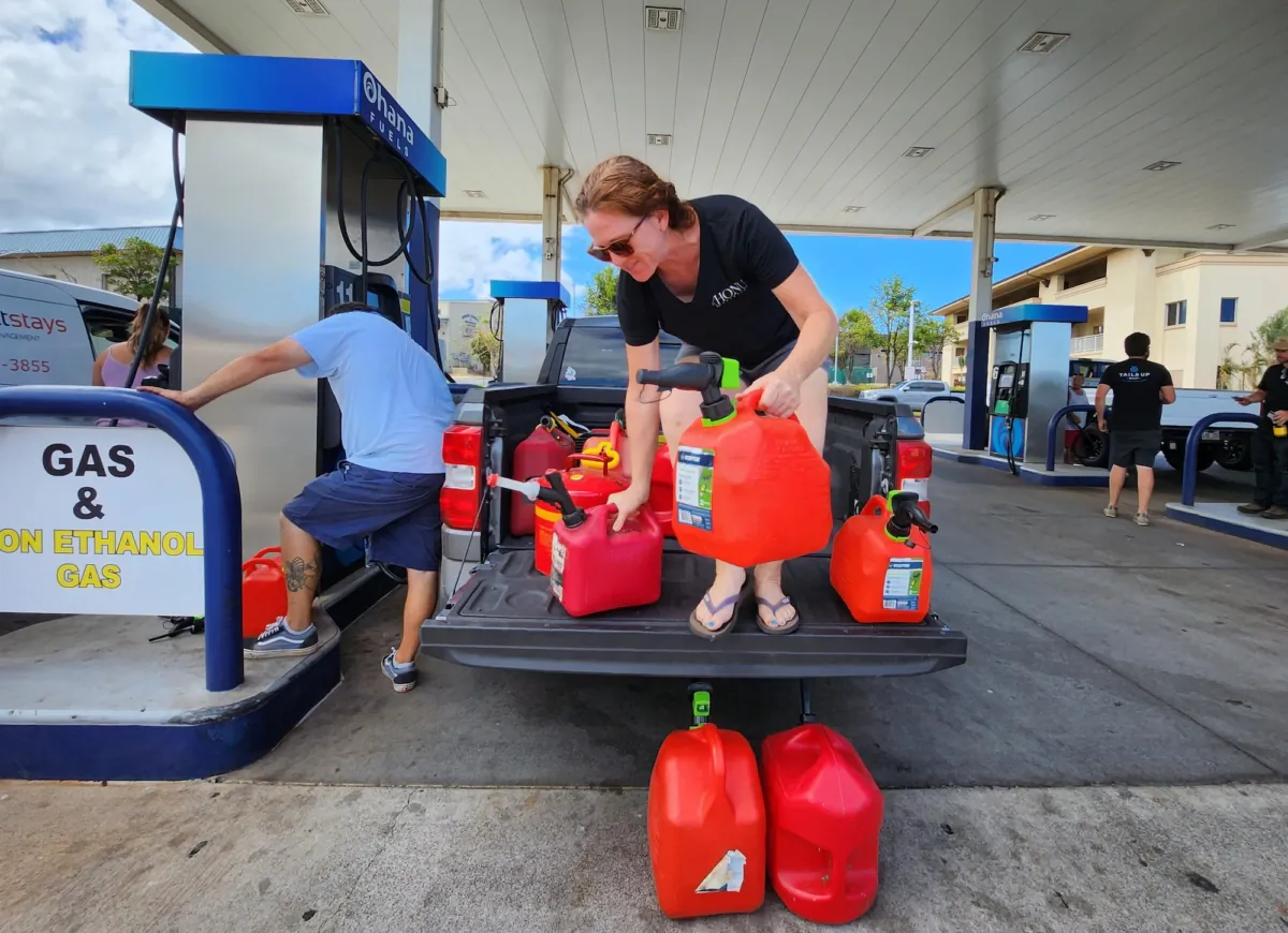 Sarah Turner of West Maui fills containers with gasoline to power her emergency generators and help her neighbors who need fuel, on Aug. 16, 2023. (Allan Stein/The Epoch Times)
