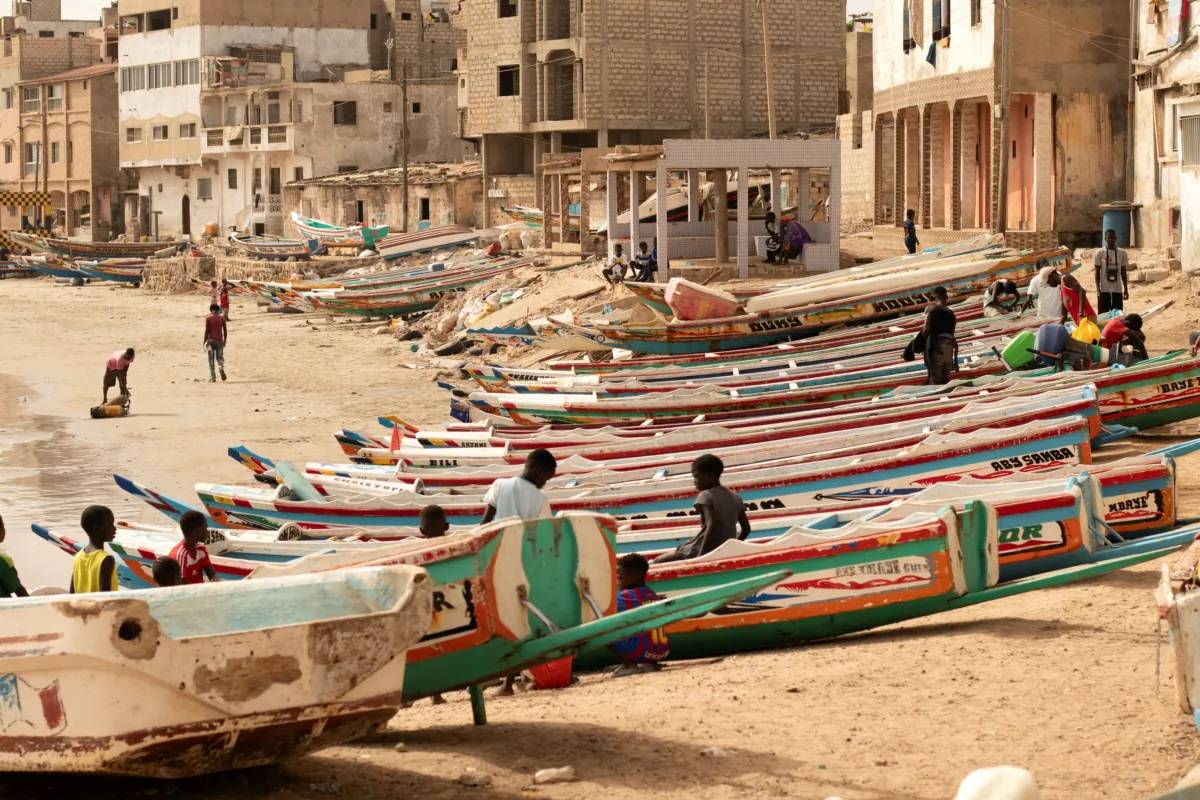 Children play on fishing boats known as “pirogues” in Dakar, Senegal, on June 24, 2023. (Zane Irwin/AP Photo)