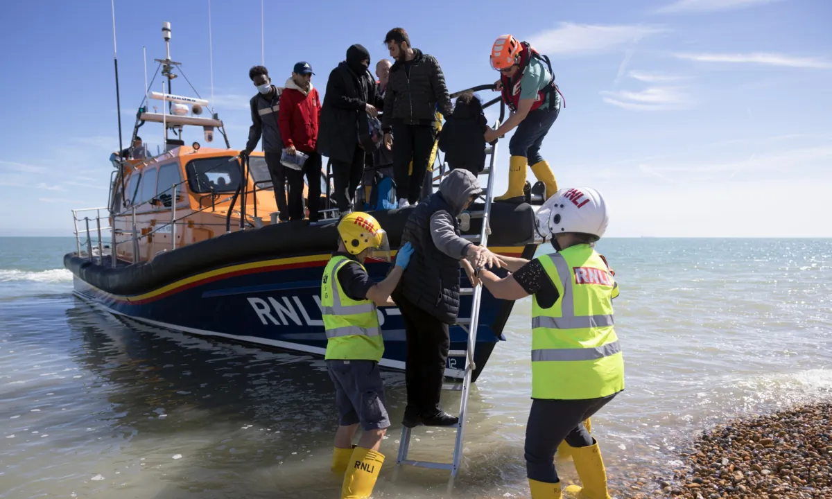 Families are helped ashore by the RNLI after being rescued in the English Channel by the RNLI in Dungeness, England, on Aug. 16, 2023. (Dan Kitwood/Getty Images)