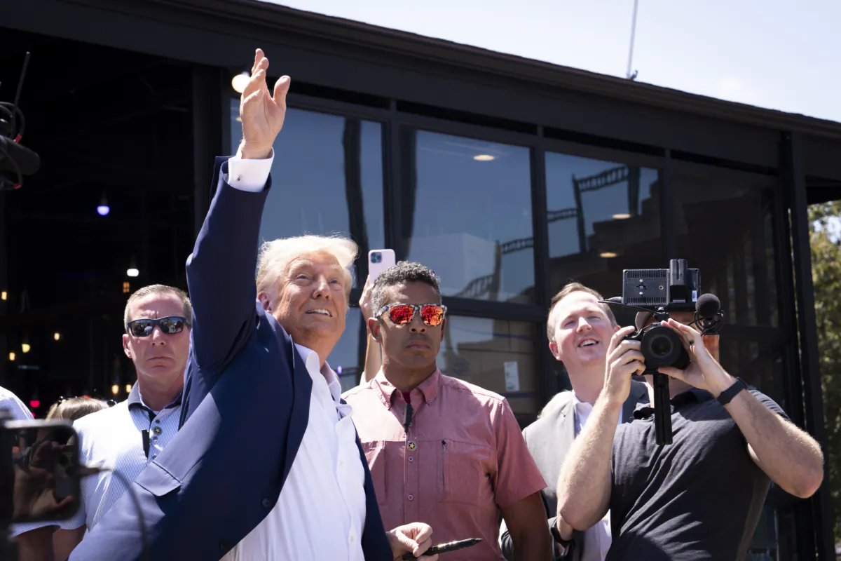 Former President Donald Trump tosses caps to the crowd at the Iowa State Fair in Des Moines, Iowa, on Aug. 12, 2023. (Madalina Vasiliu/The Epoch Times)