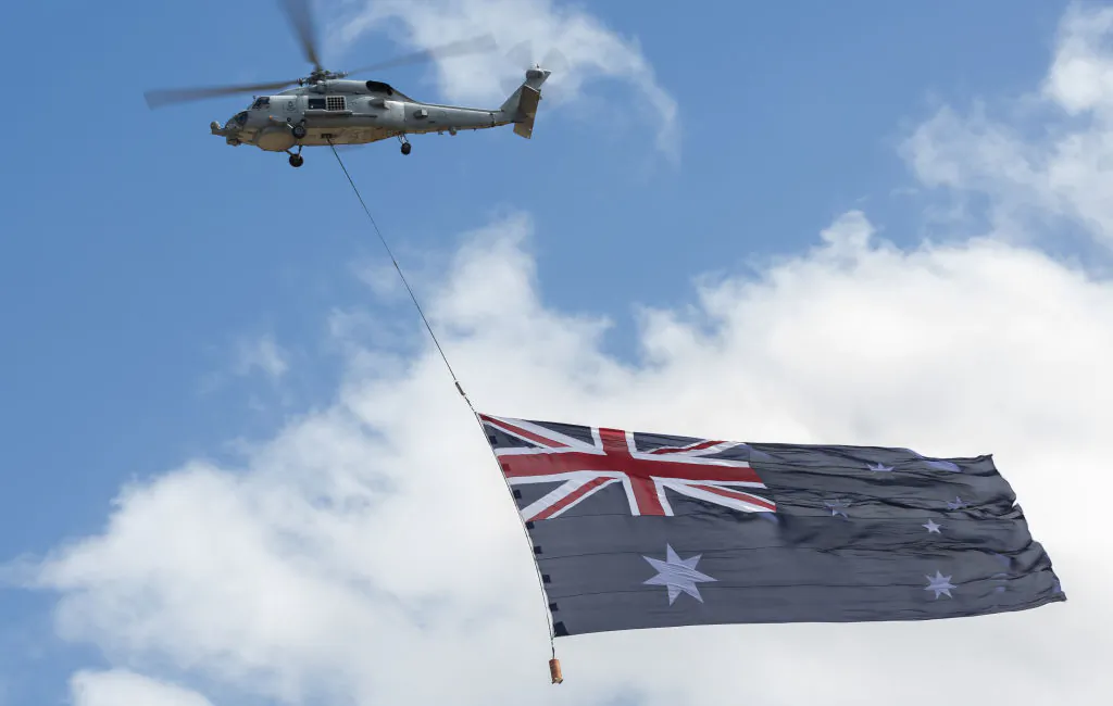 The Royal Australian Navy's MH-60R Seahawk is flying carrying the Australian Flag in Avalon, Australia on March 3, 2023. (Asanka Ratnayake/Getty Images)