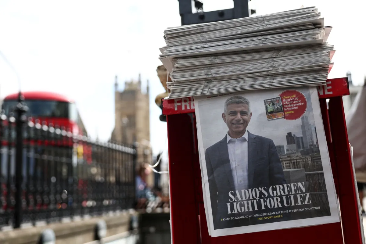 A free newspaper picturing on its front page London's Mayor Sadiq Khan following the ruling in favour, by Britain's High Court to extend Ultra Low Emission Zone (ULEZ) in London, is displayed on a self-service stand, on July 28, 2023. (Henry Nicholls/AFP via Getty Images)