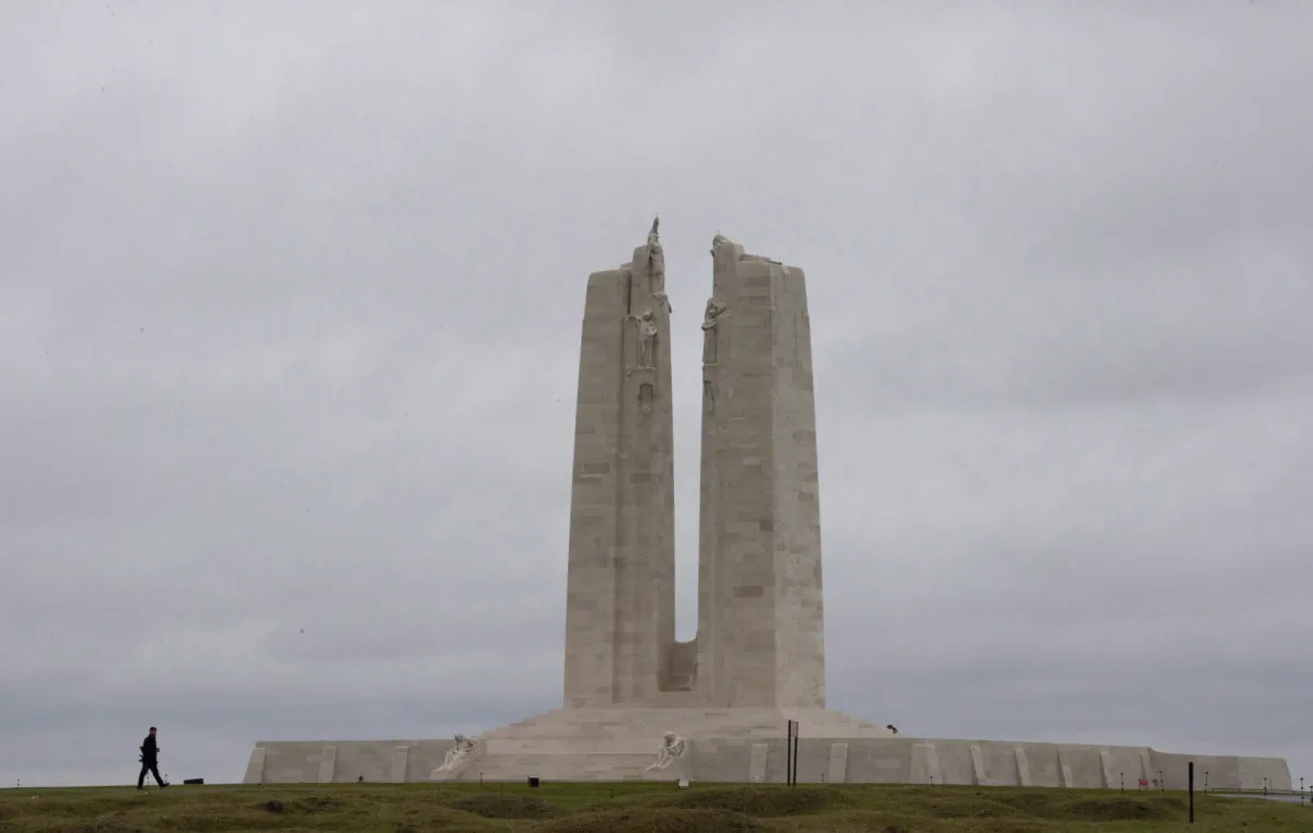 A man walks past the Canadian National Vimy Memorial following a ceremony at Vimy Ridge, France, on Nov. 10, 2018. (The Canadian Press/Adrian Wyld)