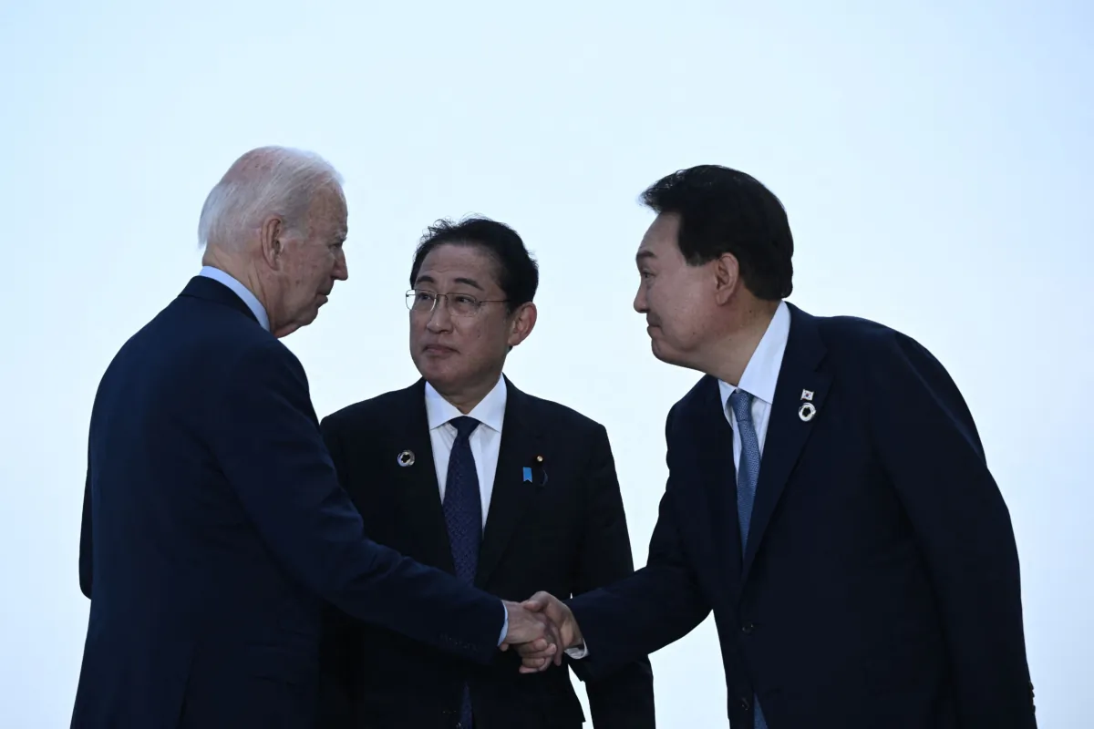 (L–R) U.S. President Joe Biden, Japan's Prime Minister Fumio Kishida, and South Korea's President Yoon Suk Yeol greet each other ahead of a trilateral meeting during the G7 Leaders' Summit in Hiroshima on May 21, 2023. (Brendan Smialowski/AFP via Getty Images)