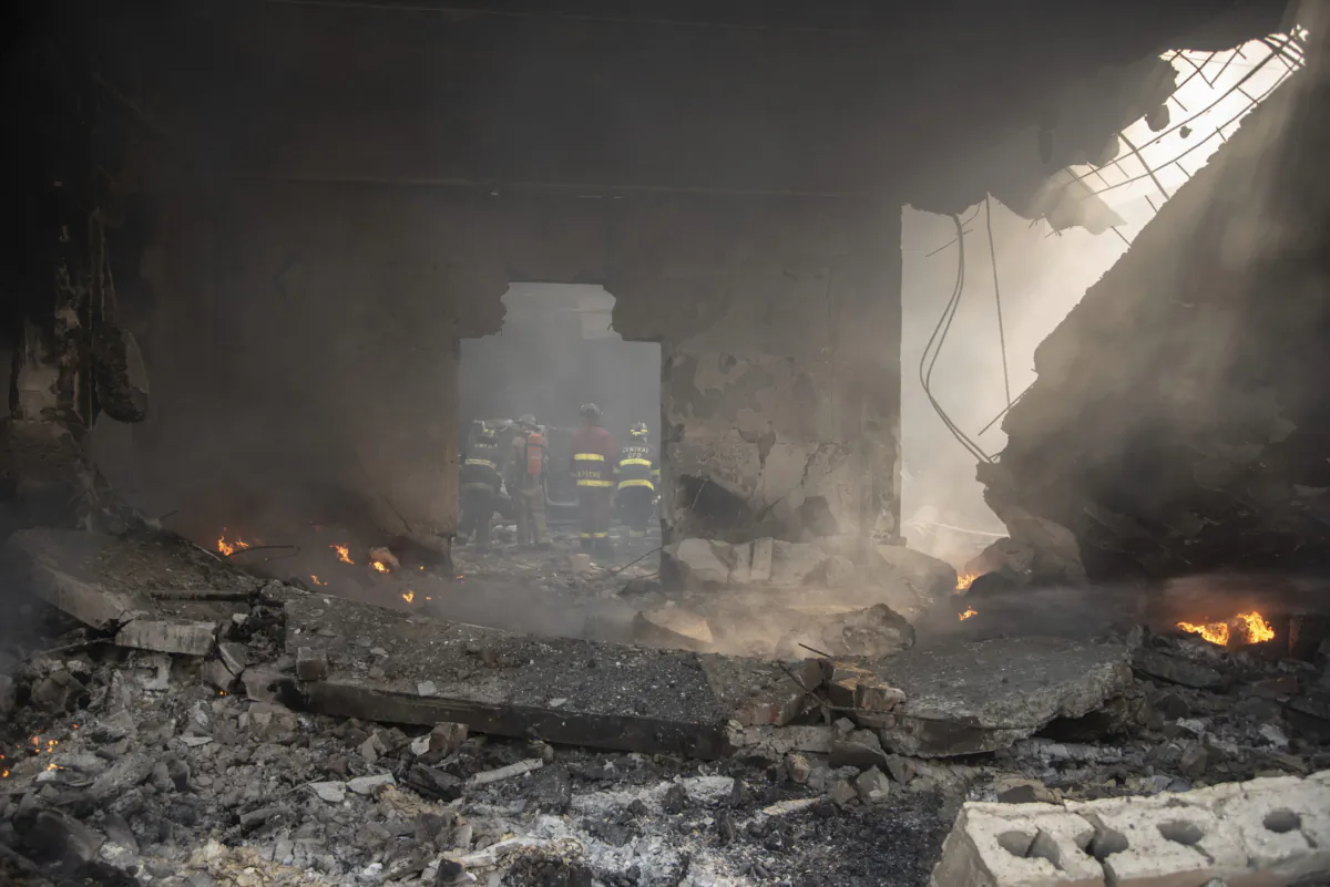 Firefighters put out a fire after a powerful explosion in San Cristobal, Dominican Republic, on Aug. 14, 2023. (Jolivel Brito/Diario Libre via AP)