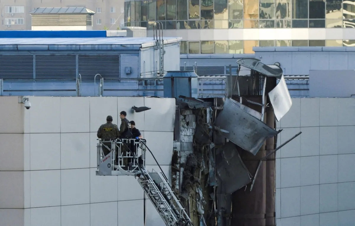 Investigators work near a damaged roof following a reported Ukrainian drone shot down in Moscow, Russia, on Aug. 18, 2023. (Shamil Zhumatov/Reuters)
