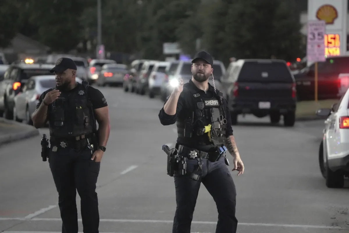 Law enforcement officers work the scene where an alleged shooting suspect was barricaded in a home in a subdivision in northeast Harris County in Houston on Aug. 17, 2023. (Brett Coomer/Houston Chronicle via AP)