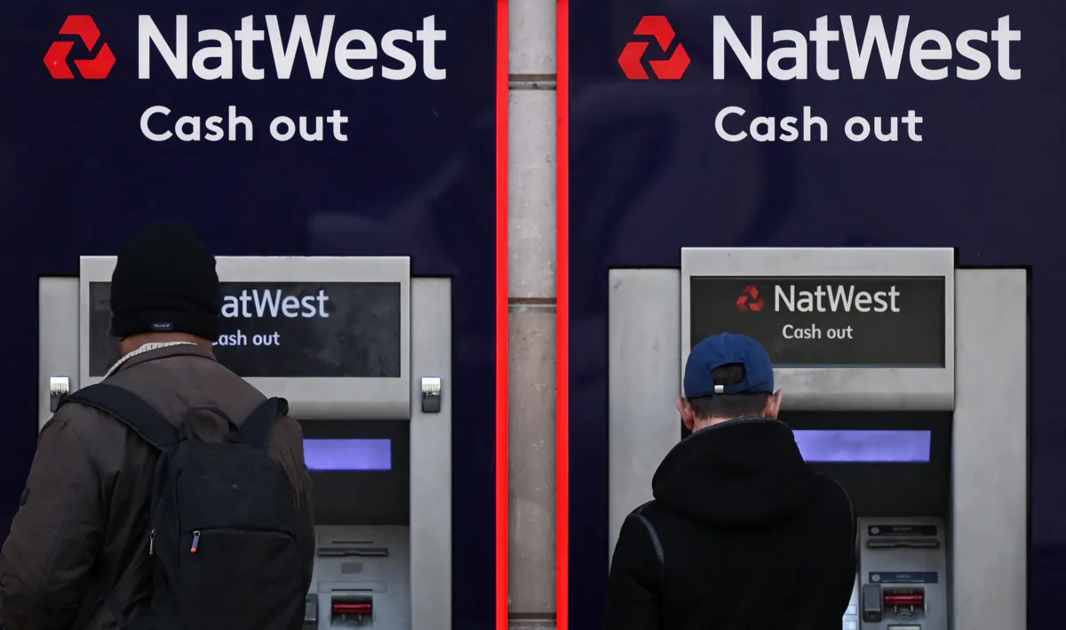 Customers use an ATM machine outside a NatWest bank branch in central London on Feb. 14, 2023. (Justin Tallis/AFP via Getty Images)