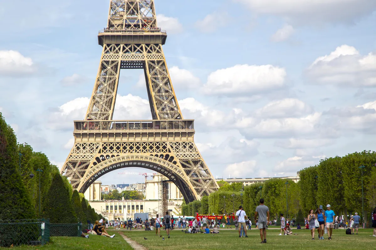 The Eiffel tower on Champ de Mars with tourists around the park on a cloudy Paris summer day in August 2019. (Juan Garcia Hinojosa Pacheco/Dreamstime/TNS)