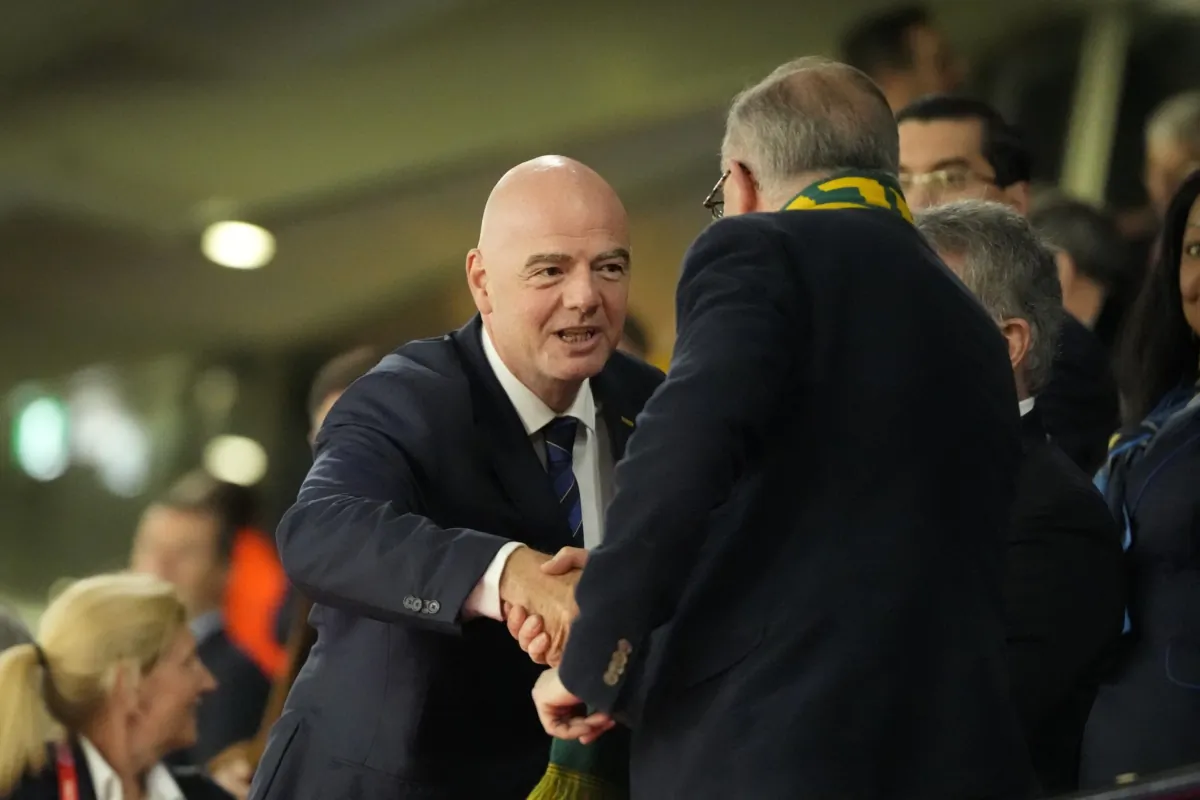 President of FIFA Gianni Infantino (L) shakes hands with Australian Prime Minister Anthony Albanese ahead of the Women's World Cup semifinal soccer match between Australia and England at Stadium Australia in Sydney on Aug. 16, 2023. (Mark Baker/AP Photo)