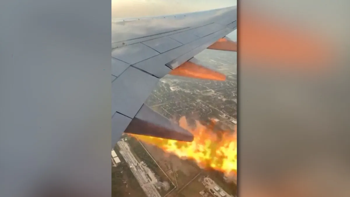 Flames shoot out of an engine of a plane mid-air between Houston and Cancun, Mexico, on Aug. 15, 2023, in a still from video. (Ricardo Garcia/Bon Voyaged/TMX via AP/Screenshot via The Epoch Times)