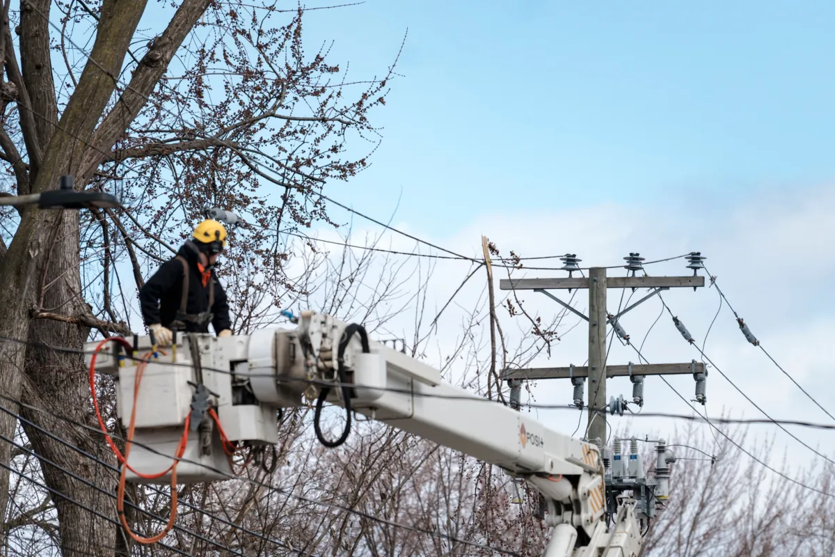 Hydro Quebec employees work on power lines in Montreal, on April 7, 2023 (Andrej Ivanov/AFP via Getty Images)