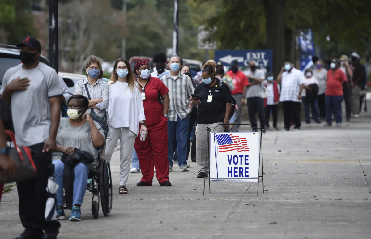 People wait in line for early voting at the Bell Auditorium in Augusta, Ga., on Oct. 12, 2020. (Michael Holahan/The Augusta Chronicle via AP)