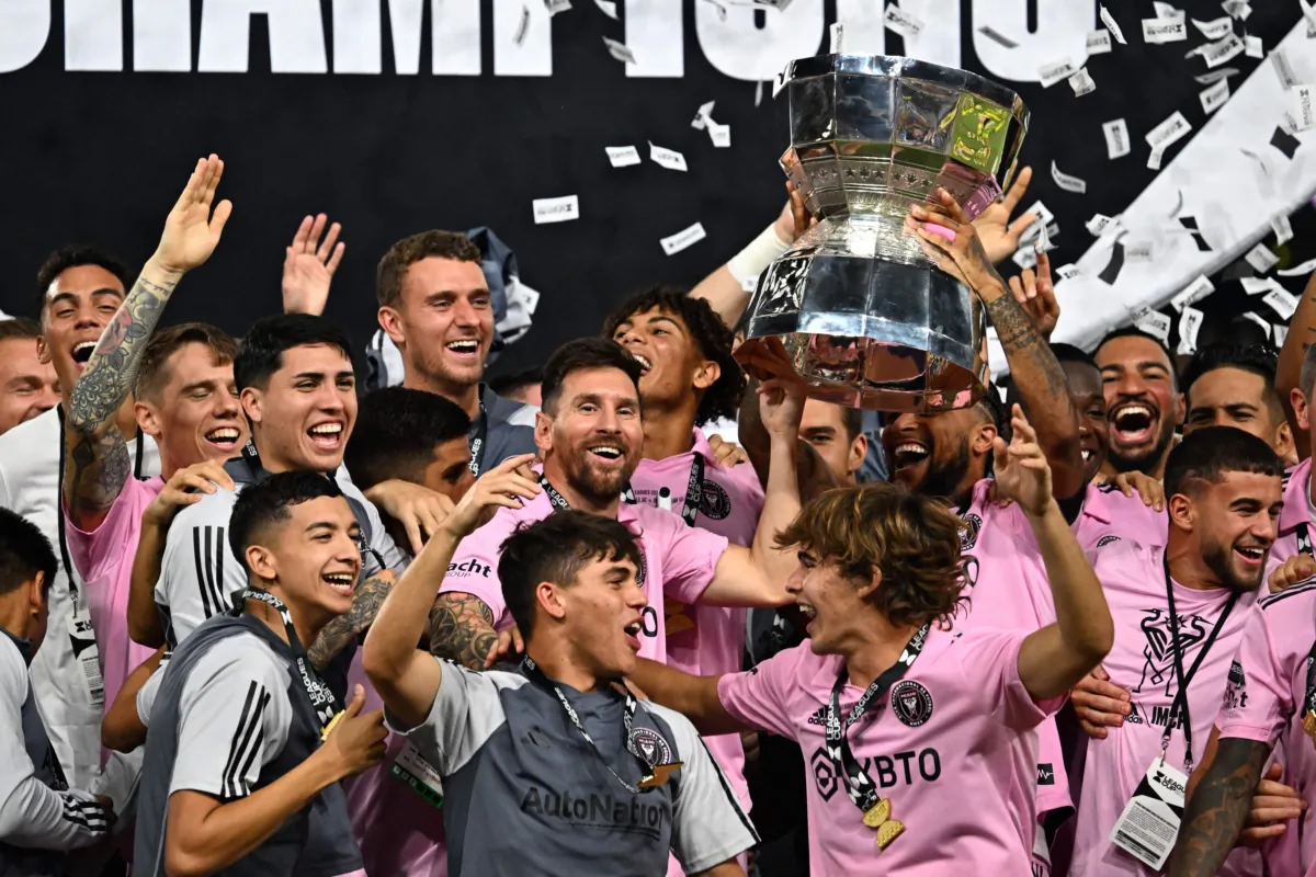 Inter Miami's Argentine forward (10) Lionel Messi and teammates celebrate with the trophy after Inter Miami won the Leagues Cup final football match against Nashville SC at Geodis Park in Nashville, Tenn., on Aug. 19, 2023. (Chandan Khan/AFP via Getty Images)