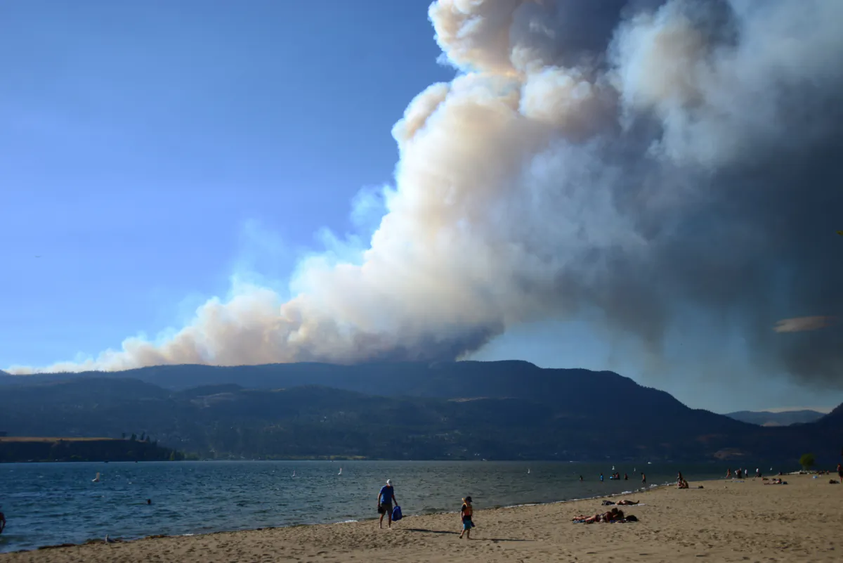 Smoke from the McDougall Creek fire drifts over Okanagan Lake from Kelowna, B.C., on Aug. 17, 2023. (Joe O'Connal/The Canadian Press)