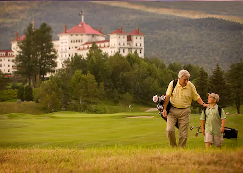 A grandfather and grandson bond over a round of golf at the Omni Mount Washington Resort in New Hampshire. (Courtesy of Omni Mount Washington Resort)