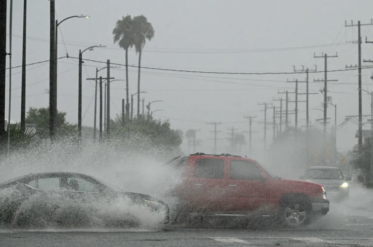Vehicles splash up water during a rainstorm in Los Angeles on Aug. 20, 2023. (Robyn Beck/AFP via Getty Images)