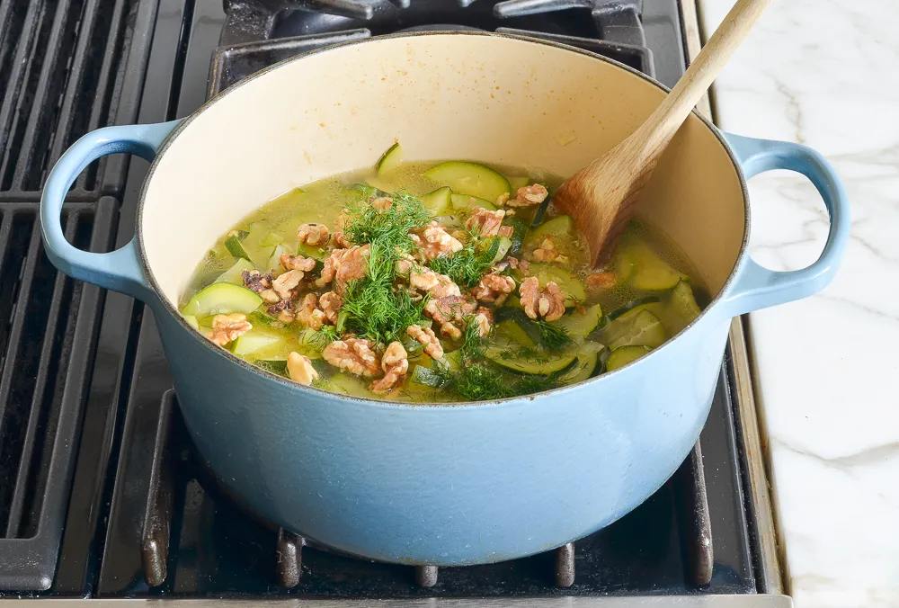 Making Creamy Zucchini Soup with Walnuts and Dill