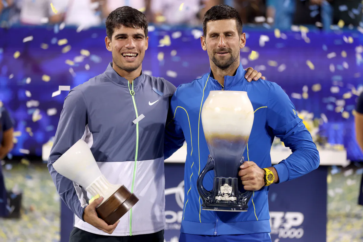 Carlos Alcaraz of Spain and Novak Djokovic of Serbia pose with their trophies after the final of the Western & Southern Open at Lindner Family Tennis Center in Mason, Ohio, on August 20, 2023. (Matthew Stockman/Getty Images)